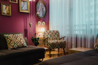 a living room with a couch and a chair at City Center Apartment with parking in Banja Luka