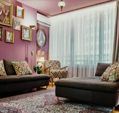 a living room with a couch and a window at City Center Apartment with parking in Banja Luka