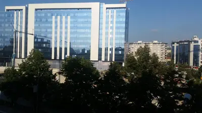 a group of tall buildings in a city with trees at City Center Apartment with parking in Banja Luka
