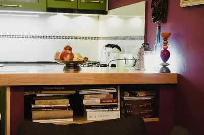 a counter with a pile of books in a kitchen at City Center Apartment with parking in Banja Luka