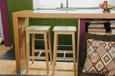 a kitchen island with two stools under a counter at City Center Apartment with parking in Banja Luka