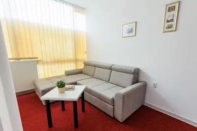 a living room with a couch and a table at Apartmani i sobe Castra in Banja Luka