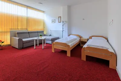 a living room with two beds and a couch at Apartmani i sobe Castra in Banja Luka