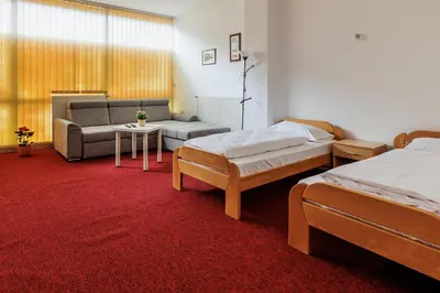 a living room with two beds and a couch at Apartmani i sobe Castra in Banja Luka