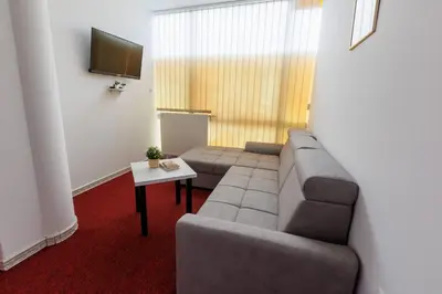 a living room with a couch and a table at Apartmani i sobe Castra in Banja Luka