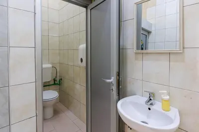 a bathroom with a sink and a toilet at Apartmani i sobe Castra in Banja Luka