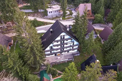 an overhead view of a large house with trees at Apartments BellaMonte Vlašić in Vlasic