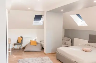 a bedroom with two beds and two skylights at Downtown Apartment Travnik in Travnik