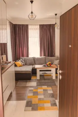 a living room with a couch and a table at Downtown Apartment Travnik in Travnik