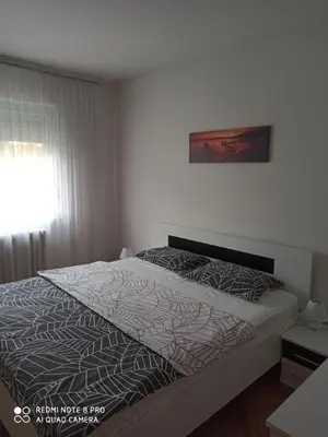 a bedroom with a bed and a window and a bed sidx sidx sidx at Apartman Mima in Banja Luka