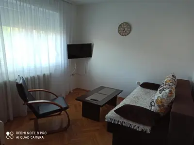 a living room with a couch and a table and a chair at Apartman Mima in Banja Luka