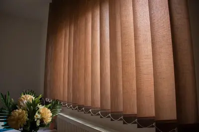 a window with a curtain and a vase of flowers at Guesthouse Vila Puzic in Banja Luka