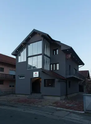 a large building with a sign on it at Guesthouse Vila Puzic in Banja Luka