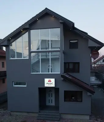 a building with a large window on the side of it at Guesthouse Vila Puzic in Banja Luka
