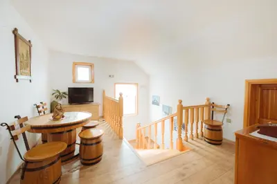a living room with a table and a tv at Lake House Bebić in Kupres