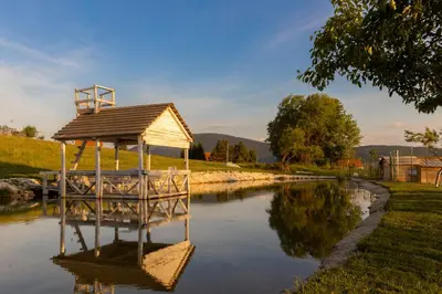 a gazebo sitting in the middle of a river at Lake House Bebić in Kupres