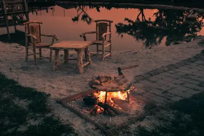 a duck sitting next to a table and a fire at Lake House Bebić in Kupres