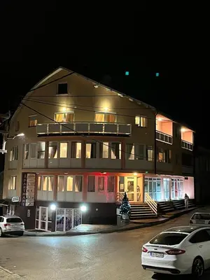 a large building with cars parked in front of it at Apartmani Li in Livno