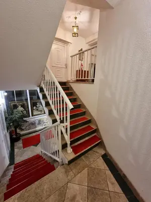 a staircase in a house with red and white stairs at Apartmani Li in Livno