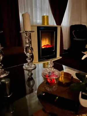 a living room with a fireplace on a table at Apartmani Li in Livno