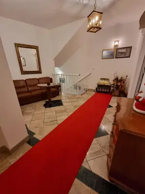 a red carpet in a living room with a red rug at Apartmani Li in Livno