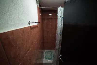 a shower with a glass door in a bathroom at Apartman Hitno in Tuzla