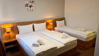 a hotel room with two beds with towels on them at Hotel Kakanj in Kakanj