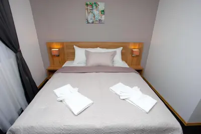 a bedroom with a bed with two white gloves on it at Hotel Kakanj in Kakanj