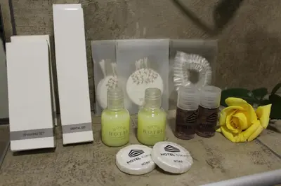 a counter with three bottles of liquid on it at Hotel Kakanj in Kakanj