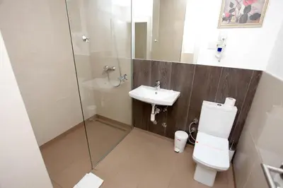 a bathroom with a shower and a toilet and a sink at Hotel Kakanj in Kakanj