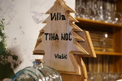 a wooden sign with the words villa than norico on it at Villa Tiha noc in Vlasic