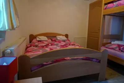 a bedroom with a bed and a bunk bed at Villa Tiha noc in Vlasic