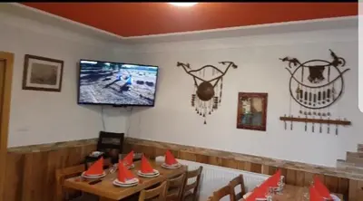 a dining room with a table with cones on the wall at Villa Tiha noc in Vlasic
