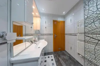 a white bathroom with a sink and a mirror at Holiday Home Villa Sara in Bihać