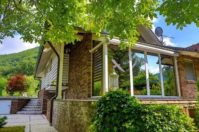 a brick house with large windows on it at Holiday Home Villa Sara in Bihać