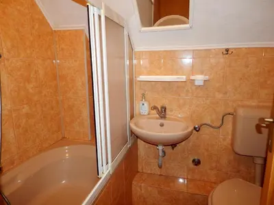 a bathroom with a sink and a tub and a toilet at Smreka Vlašić in Vlasic