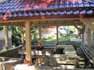 a gazebo with a fire pit under it at Smreka Vlašić in Vlasic