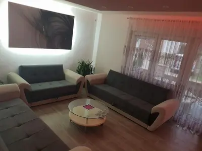 a living room with two couches and a coffee table at KAĆA APARTMANI 1 in Banja Luka