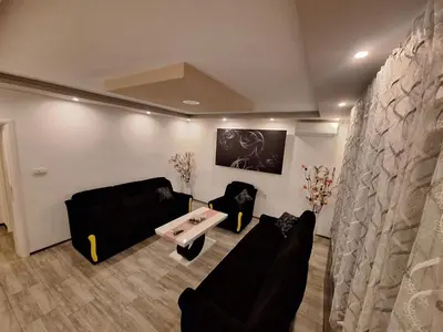 a living room with a couch and a table at KAĆA APARTMANI 1 in Banja Luka