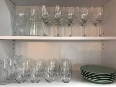 a row of wine glasses sitting on a shelf at Modern luxurious apartment in Banja Luka