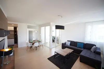a living room with a blue couch and a table at Modern luxurious apartment in Banja Luka