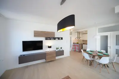 a living room with a dining table and a television at Modern luxurious apartment in Banja Luka