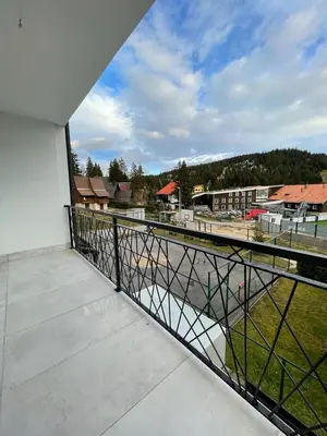 an empty balcony with a view of a building at Apartments and Rooms Ski in Vlasic