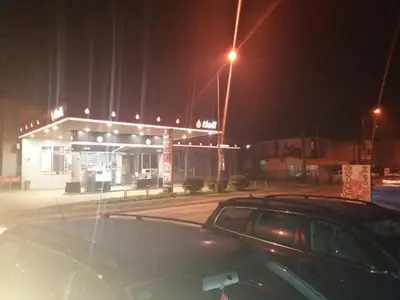 a car parked in front of a gas station at night at Rooms Adrijana in Banja Luka