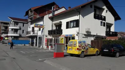 a yellow van parked in front of a building at Rooms Adrijana in Banja Luka