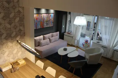 a living room with a couch and a table at Apartman Diva in Tuzla