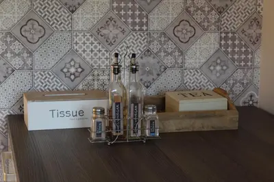 a group of bottles of wine sitting on a table at Apartman Diva in Tuzla