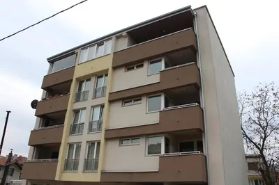a tall building with windows on the side of it at Apartman Diva in Tuzla