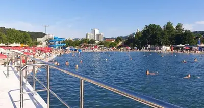 a group of people swimming in a swimming pool at Apartman Diva in Tuzla