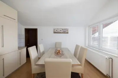 a dining room with a table and chairs at Apartman Radoš in Kupres